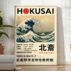 Hokusai exhibition poster featuring waves and red accents