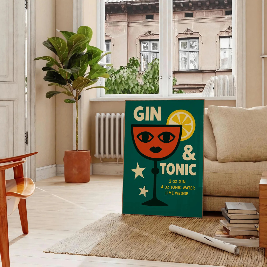 A gin and tonic cocktail with orange zest and green garnishes