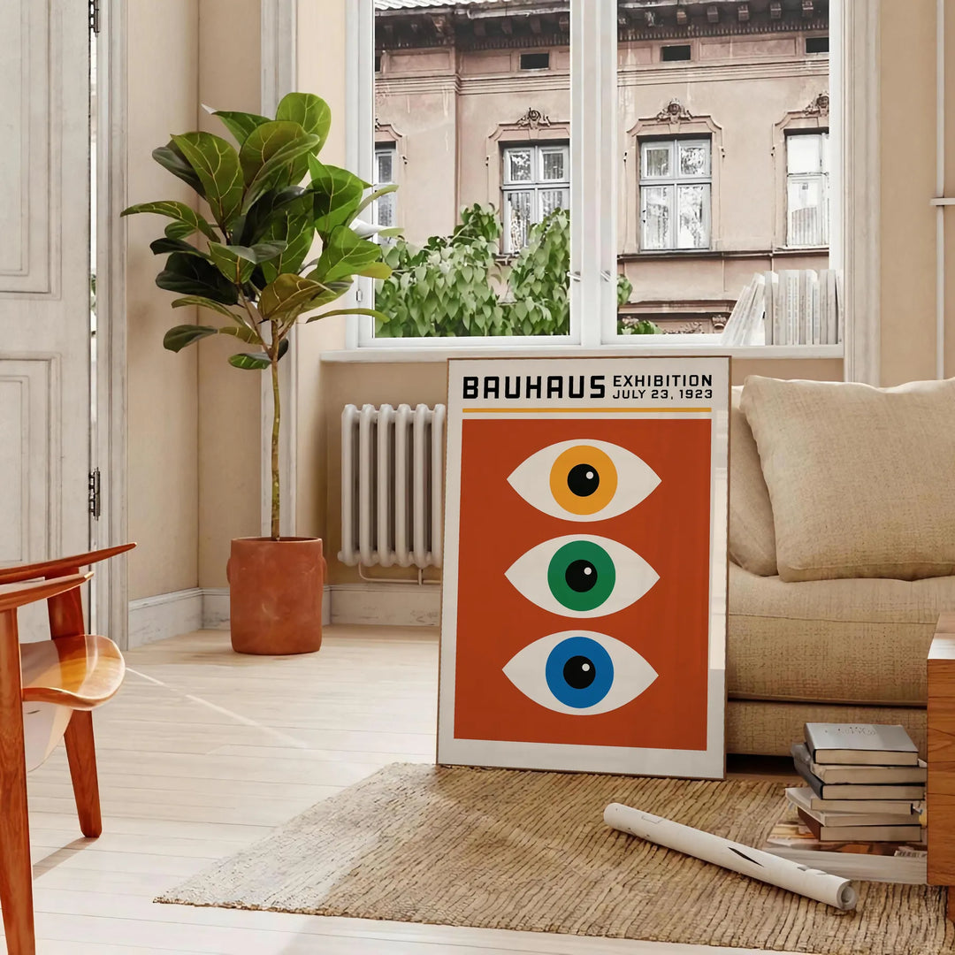 Bauhaus poster featuring stylized eyes in bold orange and green