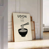 Stylized udon noodle bowl with chopsticks, orange and black graphic art