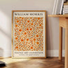 Intricate floral pattern in orange and brown by William Morris