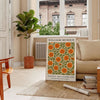 William Morris botanical design featuring intricate floral patterns in orange and green