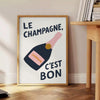 Minimalist poster featuring the French phrase 'Le Champagne C'est Bon' in green and black