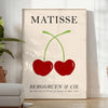 Red and orange paper-cut cherries in a mid-century style
