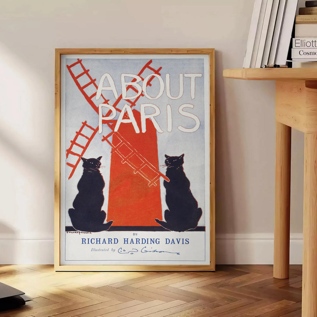 Vintage illustration of a Parisian street scene with gray and red hues - beside a round wooden side table with books