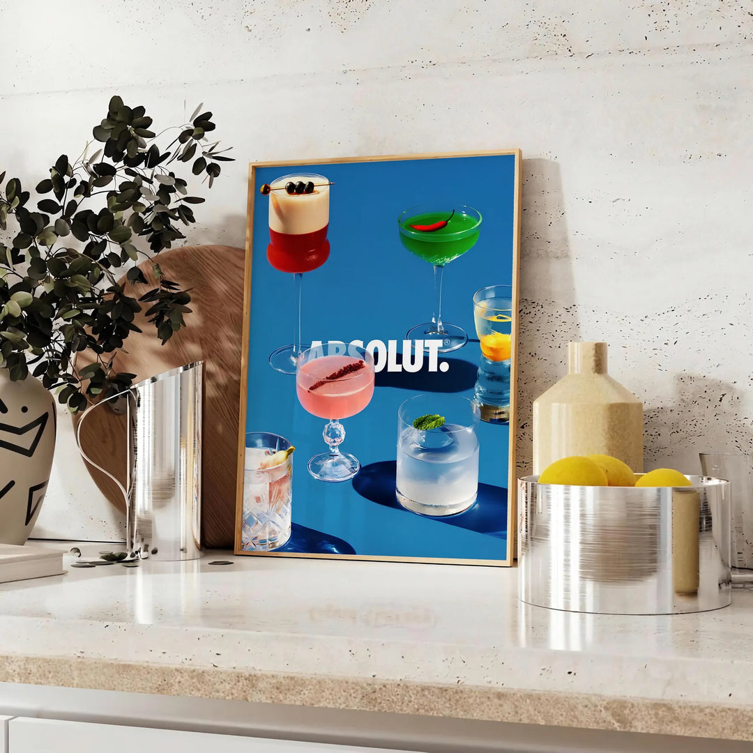 Poster of Absolut cocktail artwork in black and brown minimalist style - styled on a counter with eucalyptus and a bowl of lemons