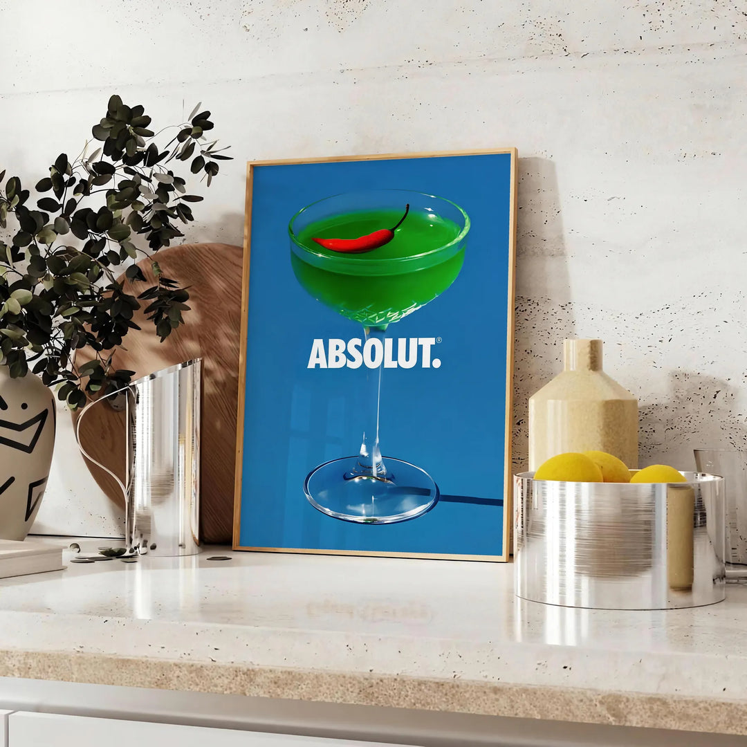 Poster of abstract cocktail artwork in brown and green tones, modern - styled on a counter with eucalyptus and a bowl of lemons