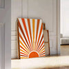 Abstract bohemian art with earthy browns and warm oranges - leaning on a herringbone floor against a white panelled wall