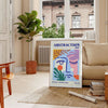 Maximalist abstract art featuring swirling shapes in blue and orange tones - in a Parisian living room with a sofa and a fig plant