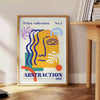 Yellow and orange maximalist abstract events poster with bold layered shapes - beside a round wooden side table with books