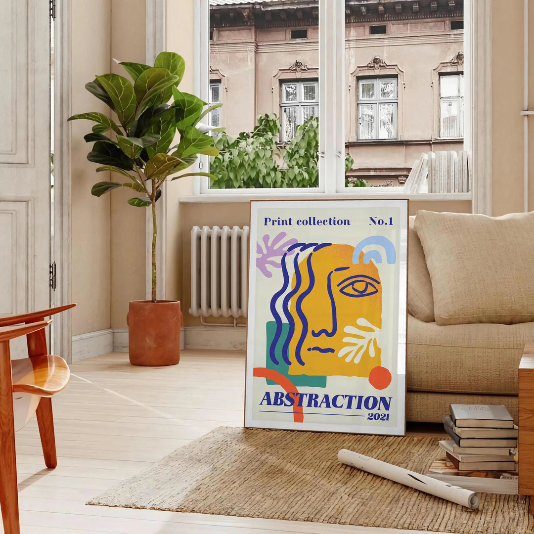 Yellow and orange maximalist abstract events poster with bold layered shapes - in a Parisian living room with a sofa and a fig plant