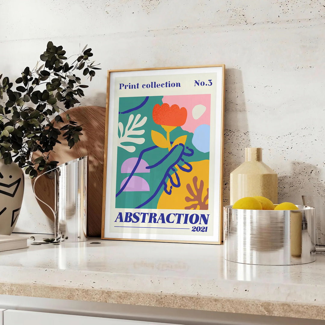 Maximalist abstract design with layered shapes in yellow and orange - styled on a counter with eucalyptus and a bowl of lemons