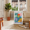 Maximalist abstract design with layered shapes in yellow and orange - in a Parisian living room with a sofa and a fig plant