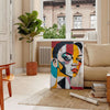 Abstract representation of a woman in green and blue tones - in a Parisian living room with a sofa and a fig plant