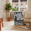 Abstract black and gray line art with flowing, minimalist shapes - in a Parisian living room with a sofa and a fig plant