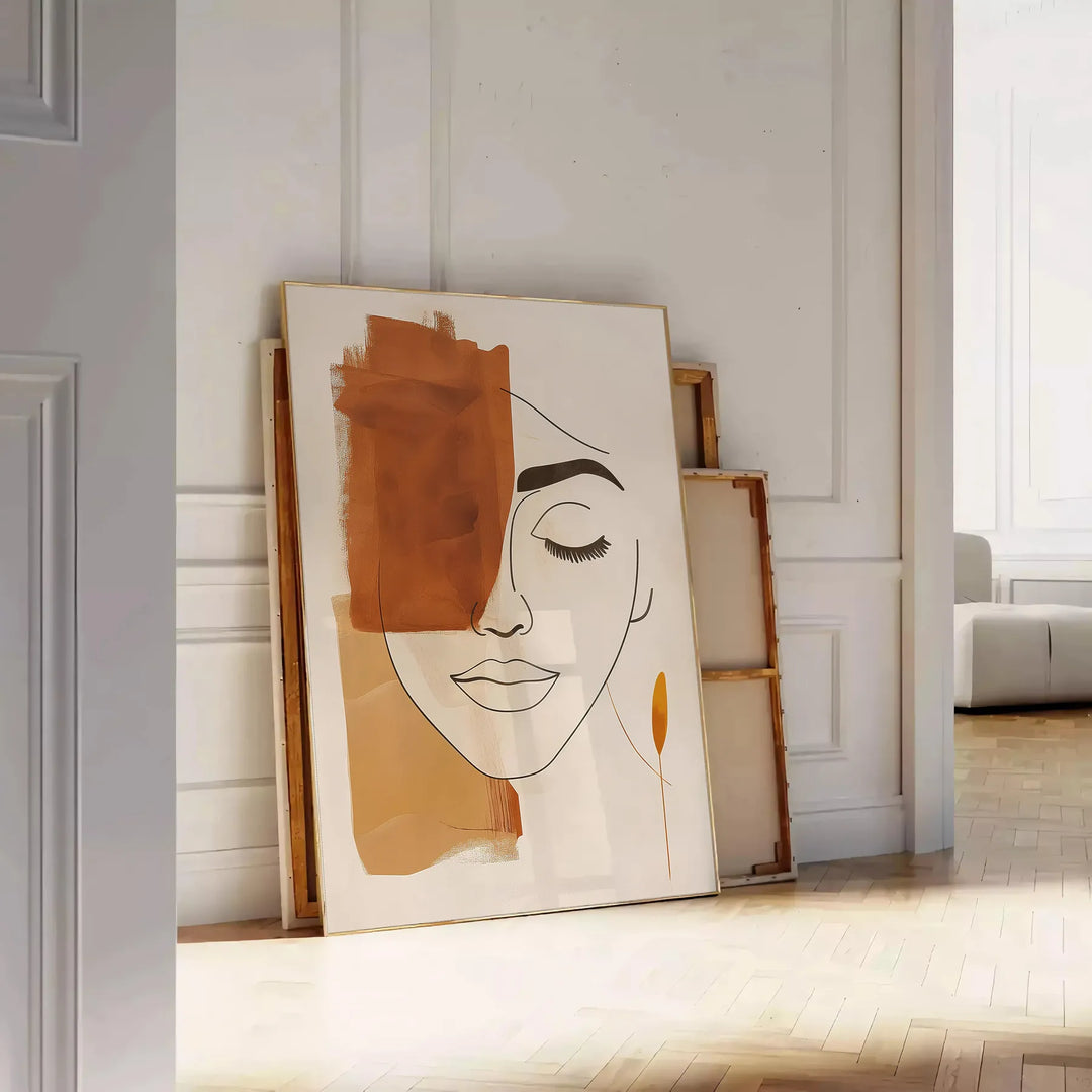 Poster showing abstract line art in green and orange, minimalist composition - leaning on a herringbone floor against a white panelled wall