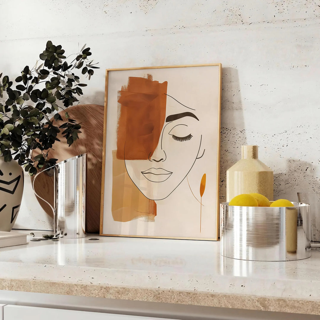 Poster showing abstract line art in green and orange, minimalist composition - styled on a counter with eucalyptus and a bowl of lemons