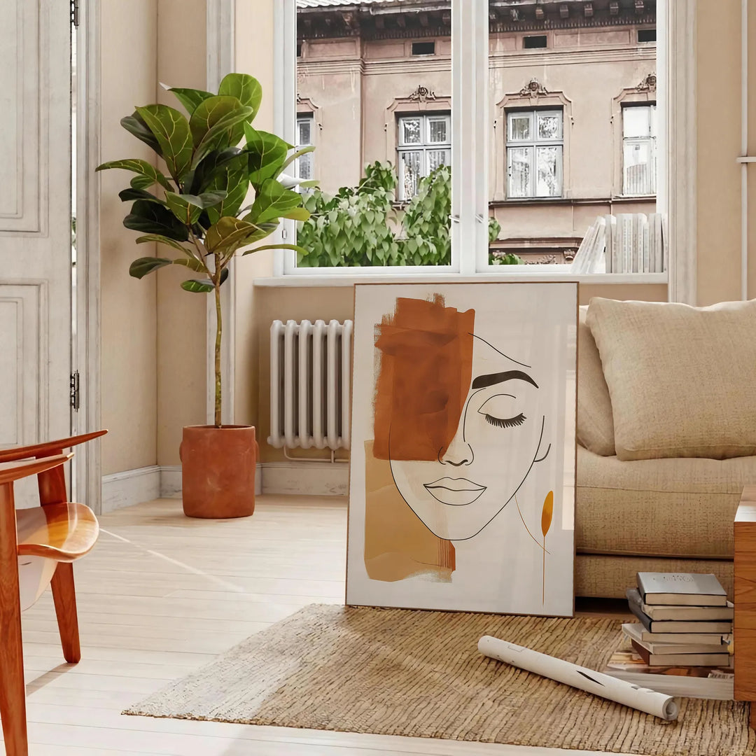 Poster showing abstract line art in green and orange, minimalist composition - in a Parisian living room with a sofa and a fig plant