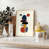 Minimalist Scandinavian abstract poster with orange and white geometric shapes - styled on a counter with eucalyptus and a bowl of lemons