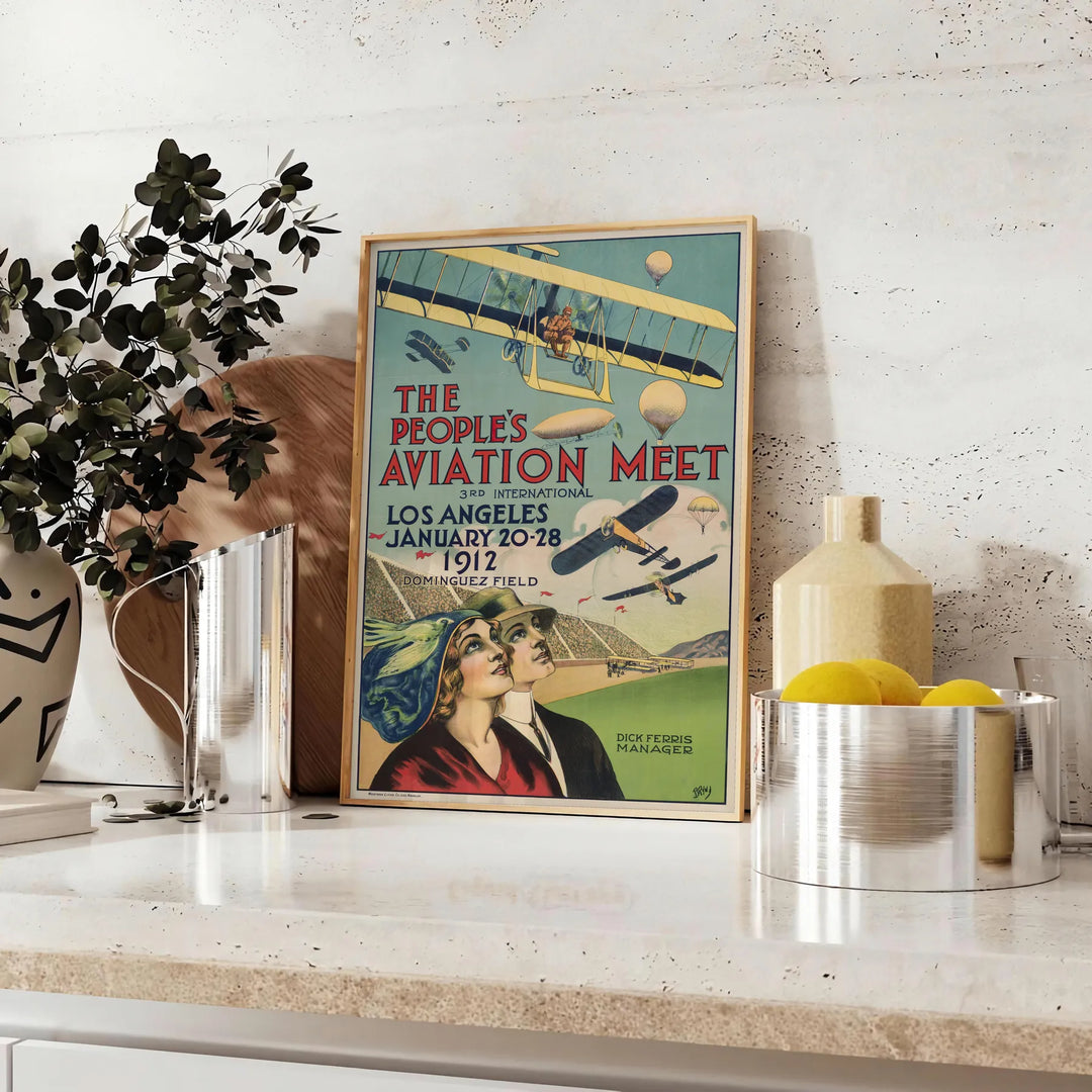 Sleek black and green airplane travel poster in minimalist graphic style - styled on a counter with eucalyptus and a bowl of lemons