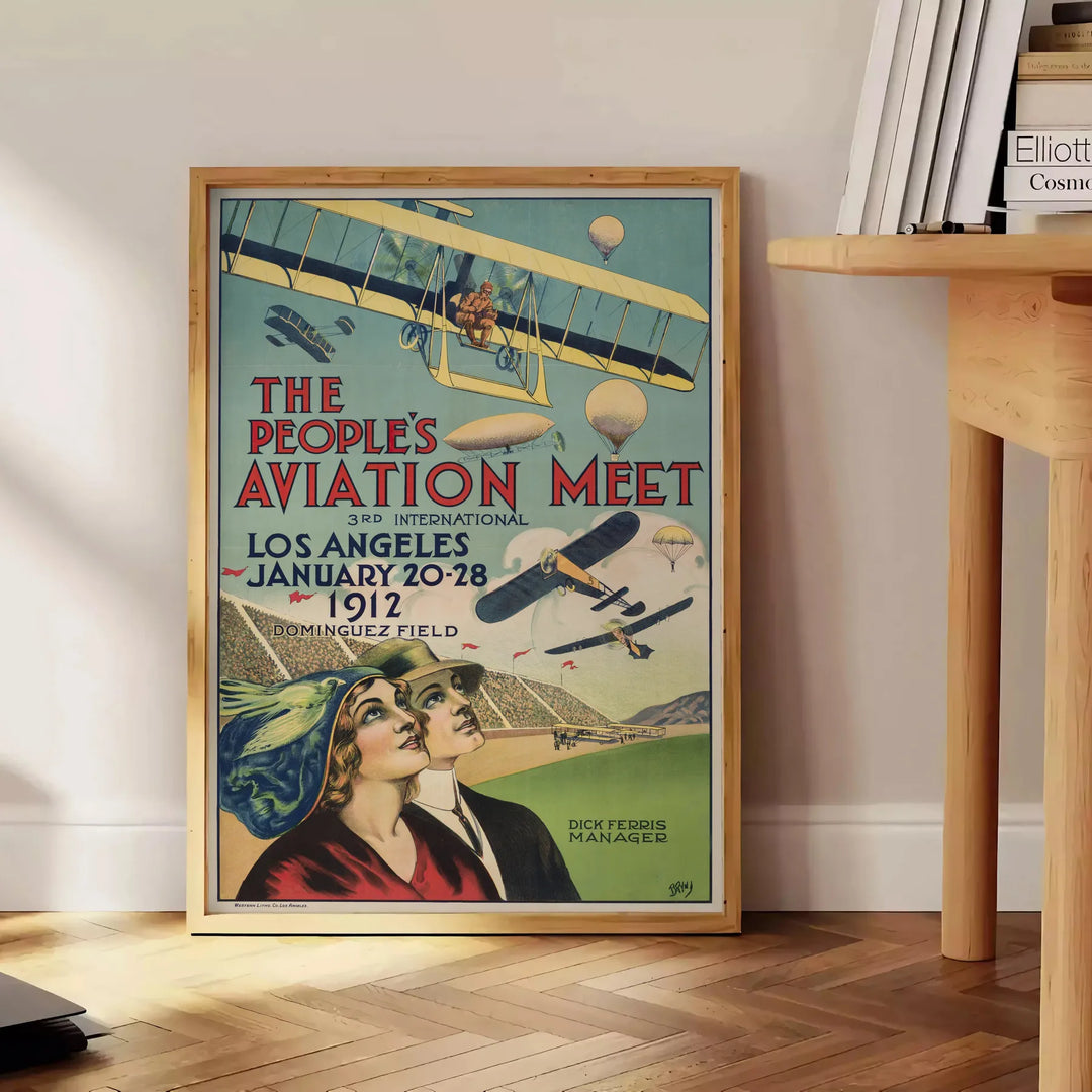Sleek black and green airplane travel poster in minimalist graphic style - beside a round wooden side table with books