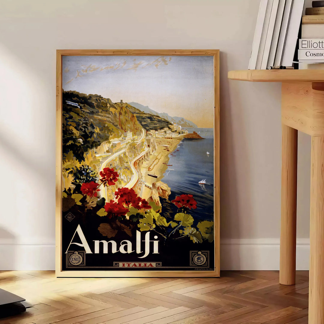 Stylized depiction of Amalfi Coast cliffs and sea in green and black - beside a round wooden side table with books