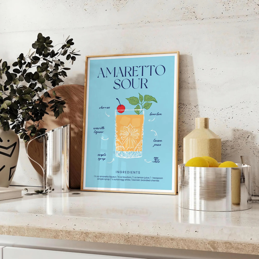 Illustration of an Amaretto Sour cocktail with splash effects in blue and yellow - styled on a counter with eucalyptus and a bowl of lemons