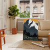 Vintage travel poster depicting Montana's green valleys under an orange sky - in a Parisian living room with a sofa and a fig plant