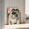 Woodblock-style poster of an angry tiger by Matsumoto Hoji with earthy tones - leaning on a herringbone floor against a white panelled wall