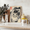 Woodblock-style poster of an angry tiger by Matsumoto Hoji with earthy tones - styled on a counter with eucalyptus and a bowl of lemons