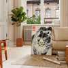 Woodblock-style poster of an angry tiger by Matsumoto Hoji with earthy tones - in a Parisian living room with a sofa and a fig plant