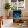 Antique oil painting depicting a lush green landscape with serene blue skies - in a Parisian living room with a sofa and a fig plant