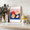 Artwork featuring a realistic apple against a textured blue background - styled on a counter with eucalyptus and a bowl of lemons