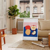 Artwork featuring a realistic apple against a textured blue background - in a Parisian living room with a sofa and a fig plant