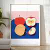 Artwork featuring a realistic apple against a textured blue background - in a bright minimalist room with a plant and an armchair