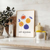 Bohemian kitchen art poster with gray and orange abstract composition - styled on a counter with eucalyptus and a bowl of lemons