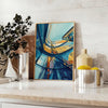 Green and blue Art Deco building painting style poster for wall - styled on a counter with eucalyptus and a bowl of lemons