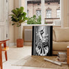 Art Deco poster featuring a jazz dancer silhouette in black and gray - in a Parisian living room with a sofa and a fig plant