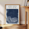 Atelier Maximalist blue and green abstract maximalist poster with layered shapes - beside a round wooden side table with books