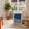 Atelier Maximalist blue and green abstract maximalist poster with layered shapes - in a Parisian living room with a sofa and a fig plant