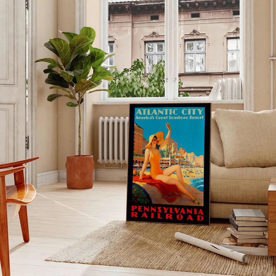 Retro illustration of Atlantic City with a beach and boardwalk in blue tones - in a Parisian living room with a sofa and a fig plant