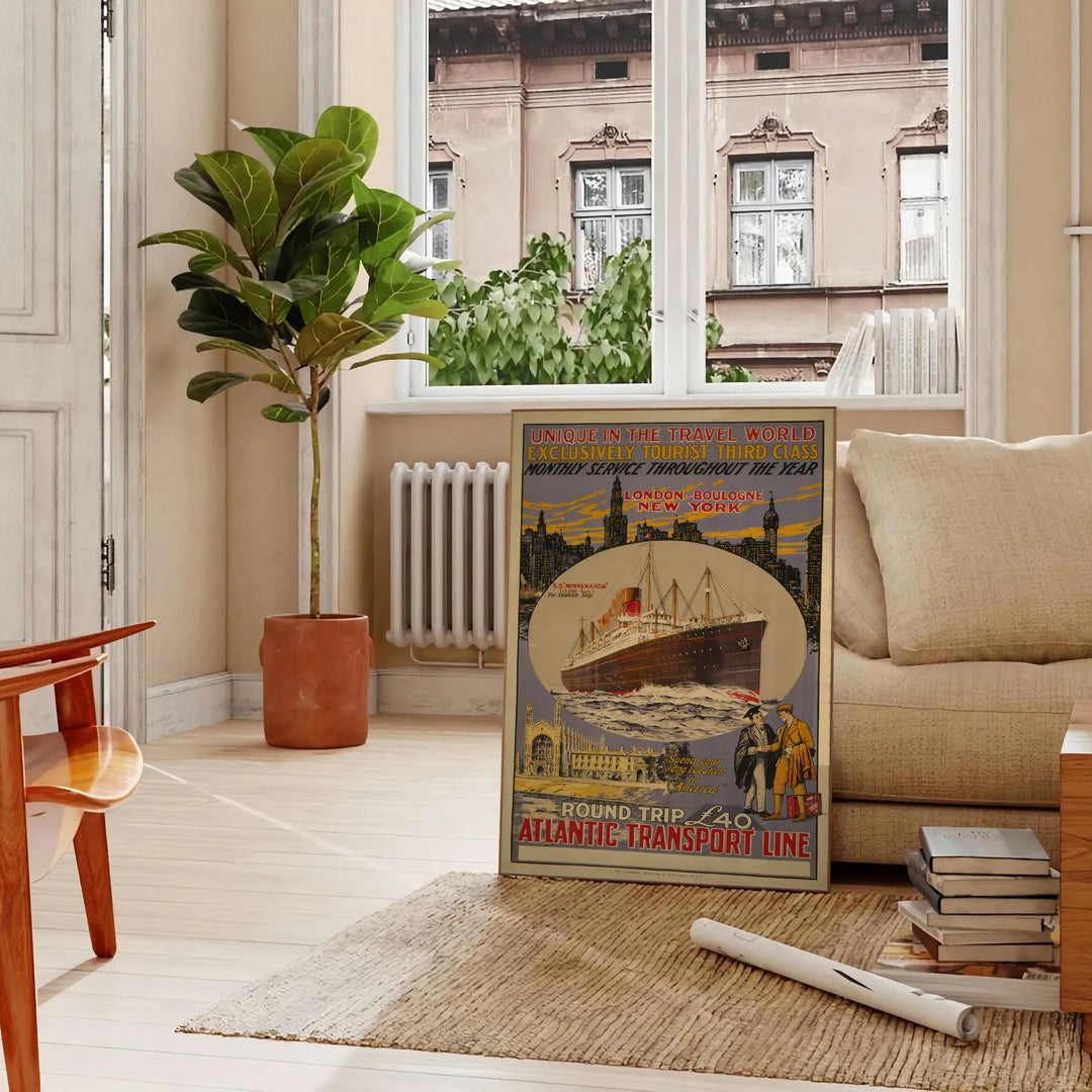 Black and gray Atlantic transport liner travel poster, vintage graphic artwork - in a Parisian living room with a sofa and a fig plant
