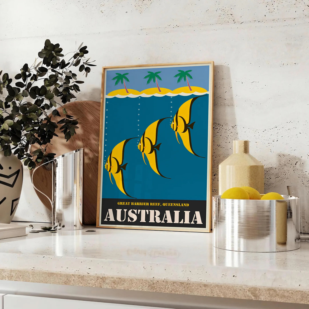 Vintage Australia travel poster with bold yellow and black graphics - styled on a counter with eucalyptus and a bowl of lemons