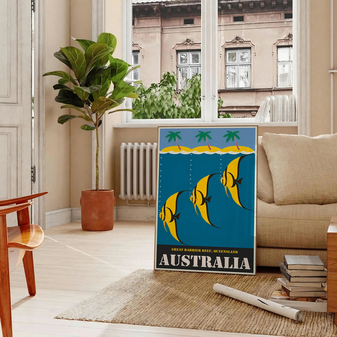 Vintage Australia travel poster with bold yellow and black graphics - in a Parisian living room with a sofa and a fig plant