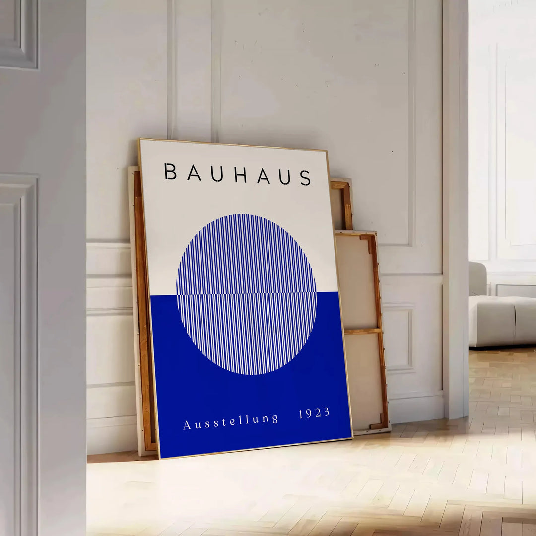 Minimal Bauhaus poster showing geometric shapes and bold composition - leaning on a herringbone floor against a white panelled wall