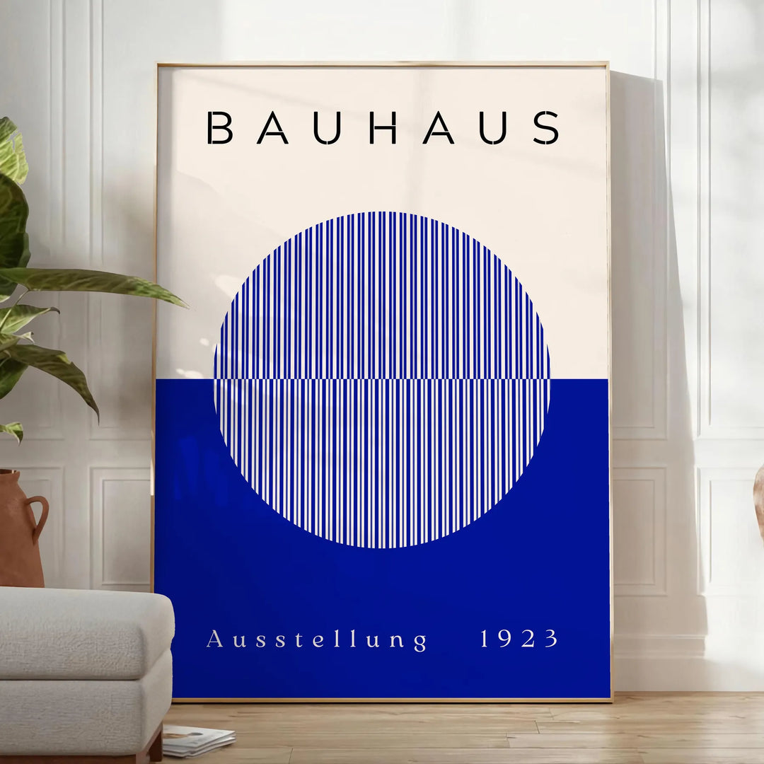 Minimal Bauhaus poster showing geometric shapes and bold composition - in a bright minimalist room with a plant and an armchair