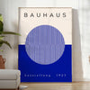 Minimal Bauhaus poster showing geometric shapes and bold composition - in a bright minimalist room with a plant and an armchair