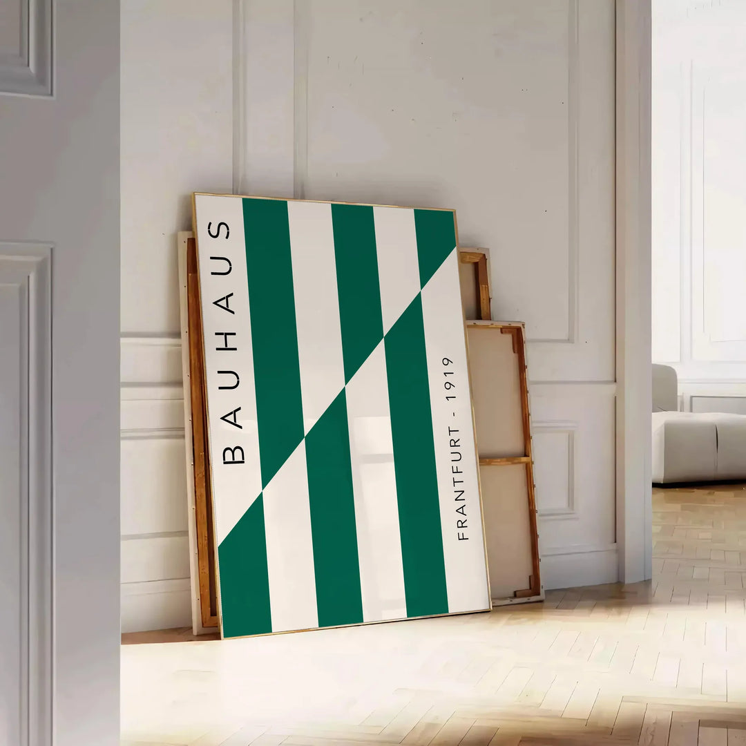 Gray and green abstract design with geometric shapes in Bauhaus style - leaning on a herringbone floor against a white panelled wall