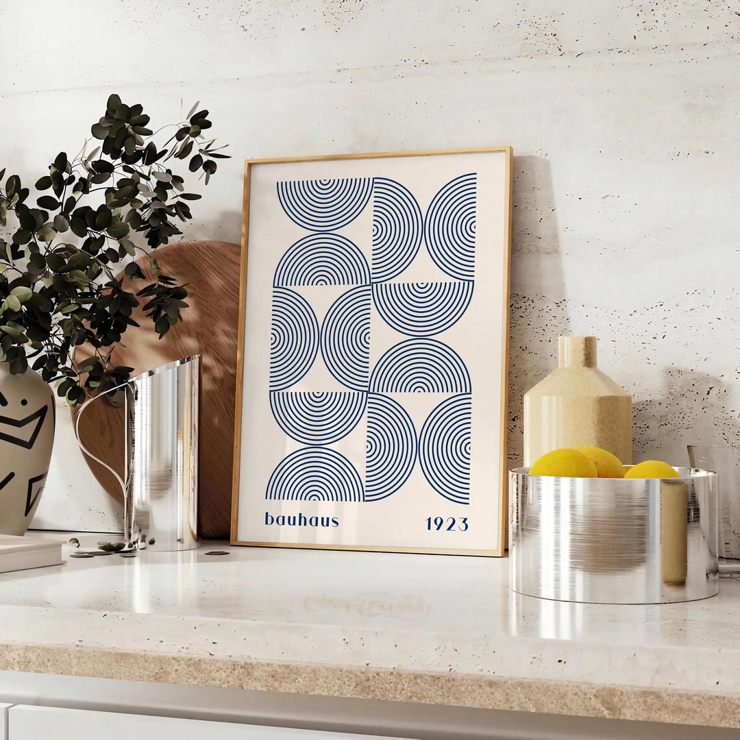 Bauhaus abstract poster with gray and blue geometric shapes, modern print - styled on a counter with eucalyptus and a bowl of lemons