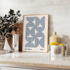 Bauhaus abstract poster with gray and blue geometric shapes, modern print - styled on a counter with eucalyptus and a bowl of lemons